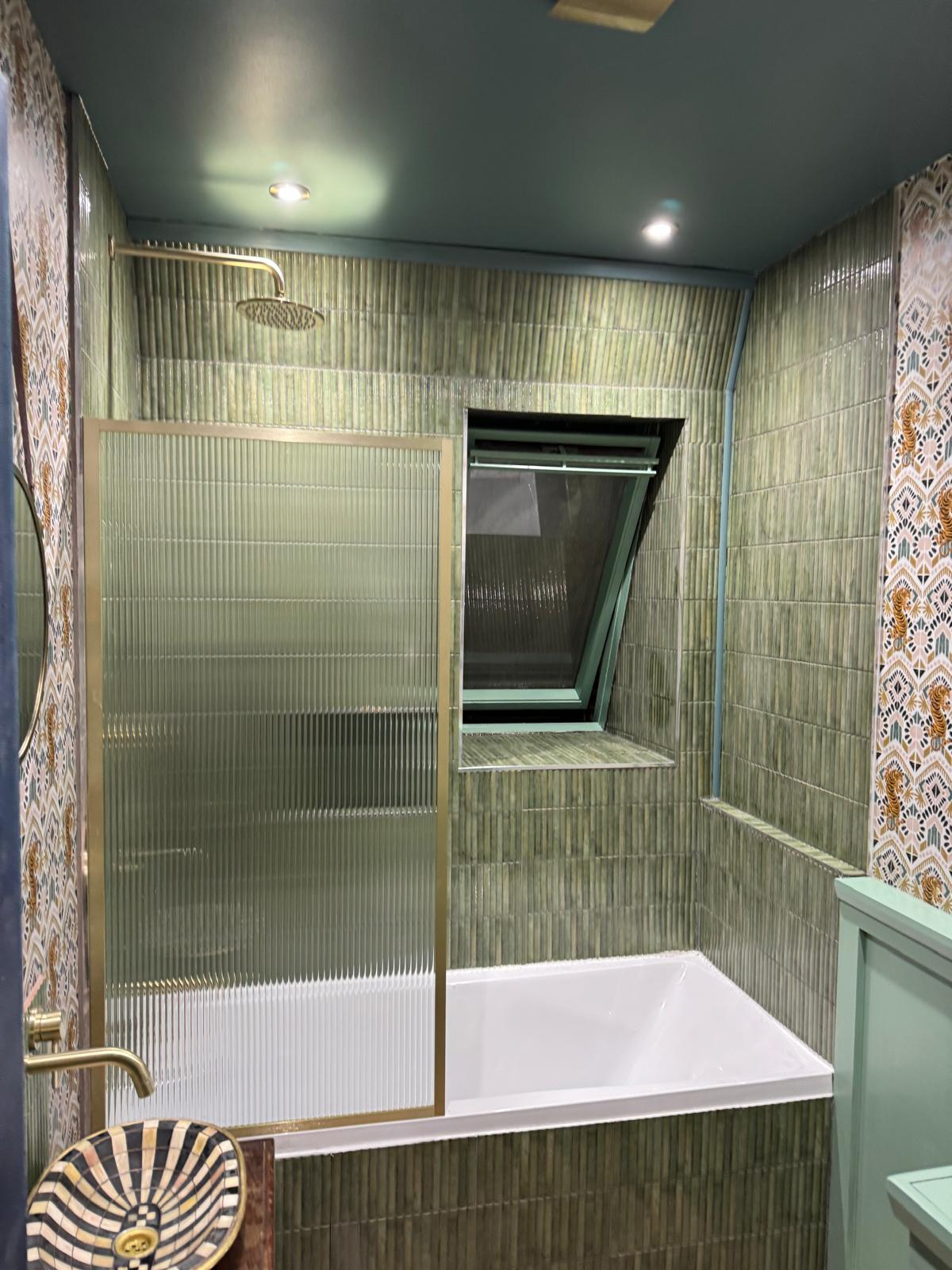 Bespoke bathroom with green reeded tiles, brass fittings and painterly wallpaper — designed and built by Ash Villa